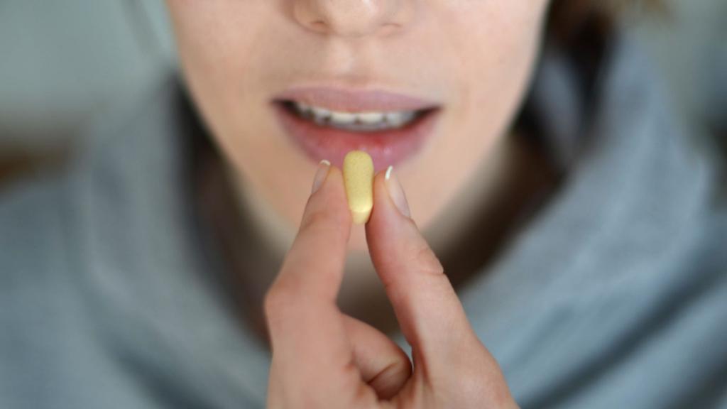 close-up-shot-of-woman-taking-medication